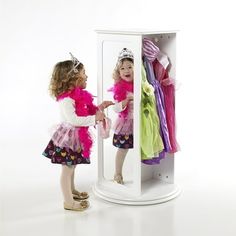 Create the perfect pretend play space for your imaginative little one using the Rotating Dress Up Storage by Guidecraft. This compact unit features a smaller footprint, making it the perfect addition to any size playroom or child's bedroom, while still providing plenty of storage. Shelves and pronged hooks accommodate all your child's favorite costumes, accessories and shoes. Two full-length, inset mirrors are just the right size, allowing children to admire their outfits. Size: 23.5 x 23.5 x 42.  Color: White. Dress Up Stations, Kids Armoire, Dress Up Storage, Pretend Play Costumes, Storage Center, Wooden Wardrobe, Kids Dress Up, Dress Up Outfits, Clothes Organization