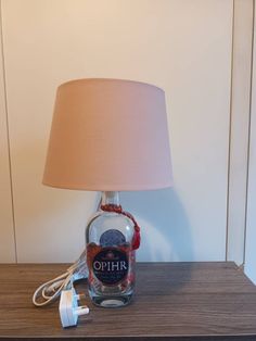 a lamp that is sitting on top of a table next to a bottle of alcohol