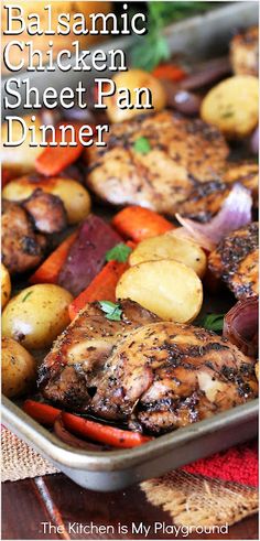 a pan filled with chicken, potatoes and carrots on top of a wooden table