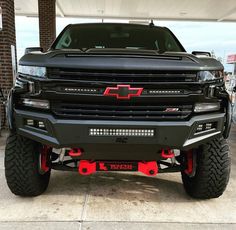 the front end of a black chevrolet truck