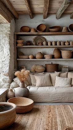 a living room filled with lots of furniture and baskets on top of the shelves next to each other