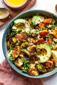 a blue bowl filled with vegetables and rice