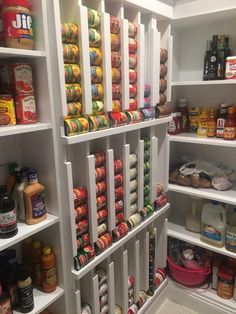 an organized pantry with lots of food and condiments on the shelves in it