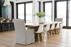 a dining room table with chairs and a vase on it