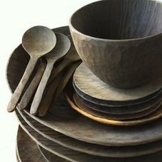 a stack of wooden bowls and spoons sitting on top of each other