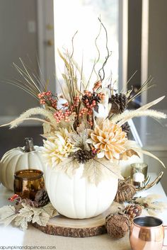 a white pumpkin filled with lots of flowers