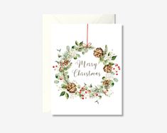 a merry christmas card with pine cones and holly