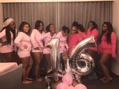 a group of women in pink posing for a photo with balloons and the number six