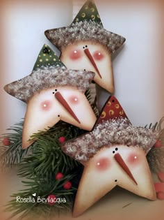 three christmas decorations are arranged in the shape of stars