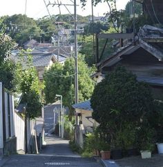 an alley way with houses and power lines in the background