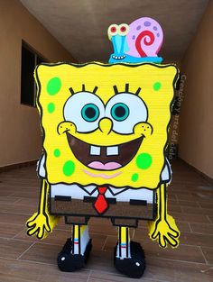 a cardboard cut out of spongebob with a birthday hat on