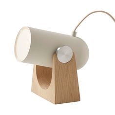 a wooden table lamp with a white light on it