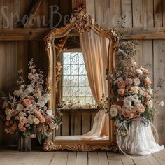 an ornate mirror with flowers on it in front of a wooden wall and windowsill