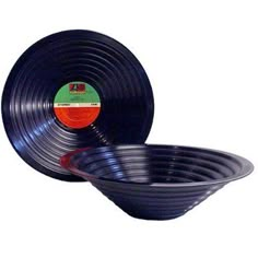 two black plastic bowls sitting side by side on top of each other in front of a white background