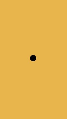 an orange background with a black dot in the center