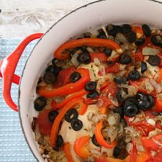 a large pot filled with lots of food on top of a table