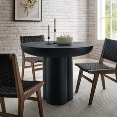 a black table and four chairs in a room with white brick walls, carpeted flooring and large windows