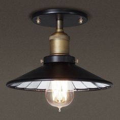 a light that is on top of a ceiling fixture with a light bulb attached to it