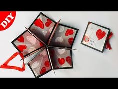 an origami box with red hearts on it