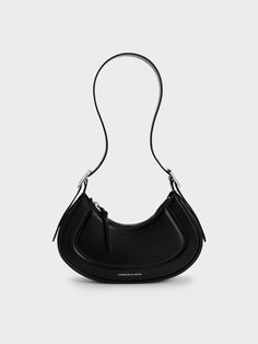 This product is made with at least 20% sustainable materials by weight. CHARLES & KEITH uses recycled, degradable, organic, and water-based materials in our eco-conscious collection.The Petra bag in sleek black is a classic piece that will effortlessly complement your existing wardrobe. Featuring a clean curved silhouette and a thick adjustible shoulder strap, this bag will sit comfortably on your shoulder - you can also choose to tucked under your arm. The main compartment offers ample space to Modern Everyday Recyclable Bags, Modern Recyclable Bags For Everyday Use, Modern Recyclable Shoulder Bag For Shopping, Modern Black Baguette Bag With Top Carry Handle, Black Double Handle Baguette Bag With Handle Drop, Black Baguette Bag With Handle Drop, Functional Recyclable Bags, Black Recyclable Tote Shoulder Bag, Modern Recyclable Bags For On-the-go