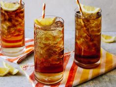 three glasses filled with iced tea and lemon slices