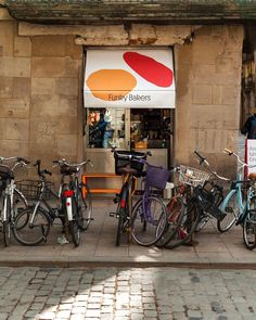 several bicycles are parked in front of a bakery