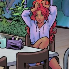 a woman with red hair sitting at a table