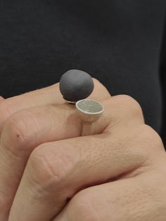 This is a 925 sterling silver double open ring. One part of the ring ends in an asymmetrical ball of matte black porcelain that looks like a stone and the other ends in a conical element that has been covered with concrete. it will stand out and is suitable for both everyday wear and special occasions. About the porcelain:There may be a slight difference between the pieces, because they are all produced handmade one by one. The porcelain is black matte,without any use of enamel and glazing, high Concrete Ring, Black Porcelain, Contemporary Ring, Hand Shapes, Contemporary Jewelry, Open Ring, Black Matte, Rings Statement, Statement Ring