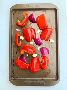 red peppers and onions on a baking sheet