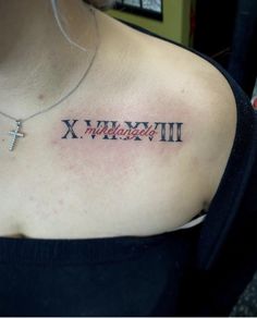 a woman with a cross tattoo on her chest that says x, y and all