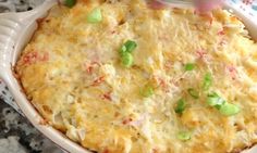 a casserole dish with green onions and cheese