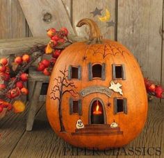 a pumpkin with an image of a house carved into it's side on the facebook page