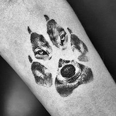 a dog's face is drawn on the wrist and it has three dogs in different colors