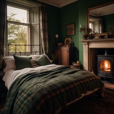 a bed sitting next to a fire place in a room with green walls and wood flooring