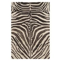 a zebra print rug with black and white stripes on the bottom, in front of an off - white background