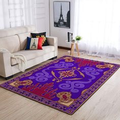 a living room with a white couch and purple rug on the floor next to a window