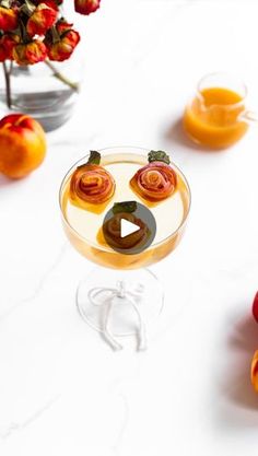 a glass with some fruit in it on a table