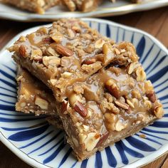 three pieces of pecan bar on a blue and white plate