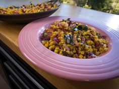 two plates filled with food sitting on top of a wooden table next to each other