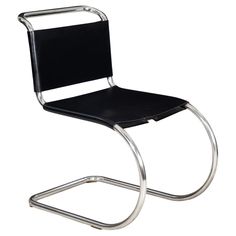 a black chair that is sitting on a metal frame and has a seat up against it