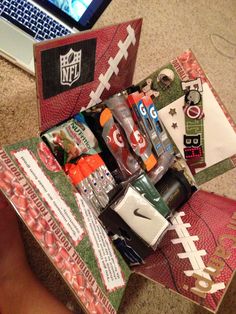 an open football themed gift box on the floor