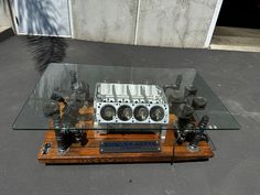 the engine block is on display in front of a glass table with metal fittings