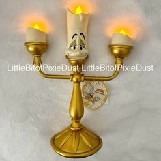 a disney character candle holder with three candles