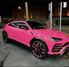 a pink lamb suv parked on the street