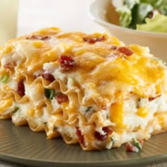 a casserole dish with cheese, bacon and spinach in it on a plate