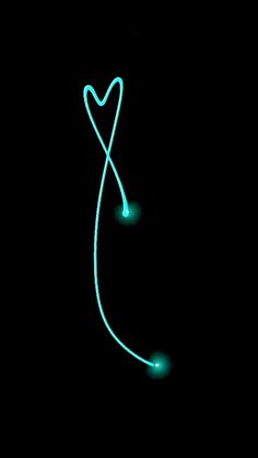 a heart shaped string is glowing in the dark with blue light on it's end