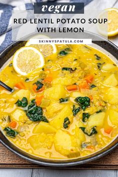 a bowl of red lentil potato soup with lemon and spinach on the side