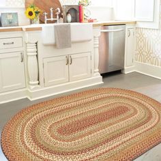 a kitchen area with sink, dishwasher and rug