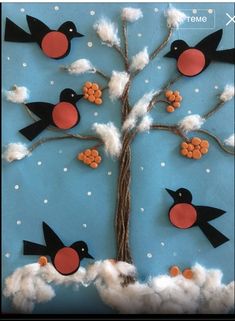 a paper tree with birds and snow on it