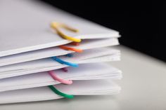 a stack of papers with colored paper clips sticking out of them royalty images and stock photos